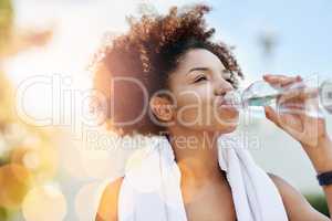 Maintaining good hydration also supports healthy weight loss. Cropped shot of a young woman enjoying a bottle of water while out for a run.