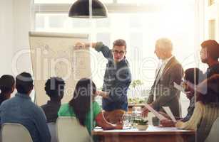 Charting their successes. Shot of a group of coworkers in a boardroom meeting.