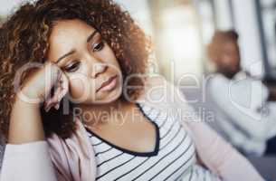 Arguments are a part of every relationship. Shot of a young woman looking despondent after having a fight with her boyfriend at home.