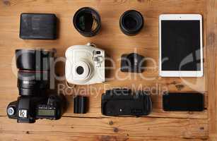 Everything you need to be a photographer. High angle shot of wireless technology and camera equipment.