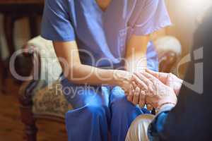Committed to comfort and care. Shot of a resident being consoled by a nurse in a retirement home.