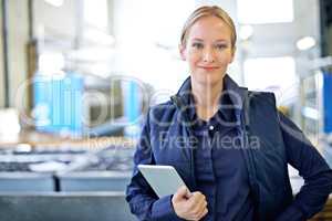 Ive got this warehouse running smoothly. Portrait of an attractive young female worker in a warehouse.