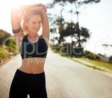 Get the blood flowing and get going. Shot of a fit young woman stretching before a run outdoors.