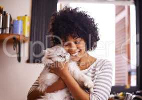 Arent you so cute. Shot of a beautiful young woman enjoying a cuddle with her cat.