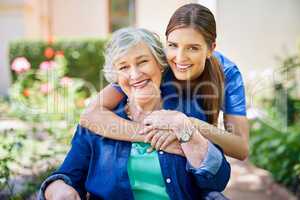 Making her stay as pleasant as possible. Shot of a resident and a nurse outside in the retirement home garden.