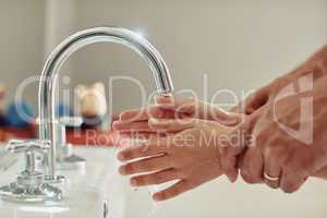 Just like daddy showed you. Cropped shot of an unidentifiable father showing his little girl how to wash her hands.