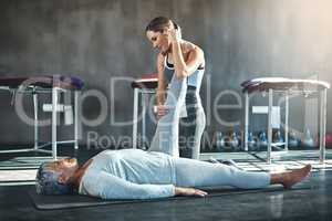 Building balance and strength for a better quality of life. Shot of a senior woman working out with her physiotherapist.