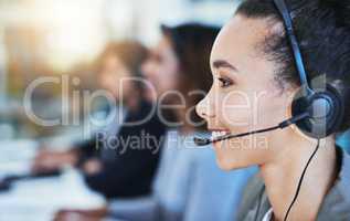 Allow me to direct your call. Shot of a young woman working in a call centre.