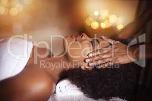 Life doesnt get any better than this. Shot of a young woman getting a head massage at a beauty spa.
