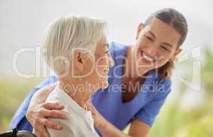Friendly nurse doctor offering patient support during recovery. A loving caregiver taking care of her patient and showing kindness while doing a checkup in assisted living home