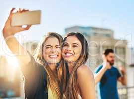 Say cheese. Shot of young female friends taking a selfie outside.