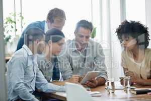 Lets browse for a few ideas. Shot of a group of professionals using wireless technology during a meeting.