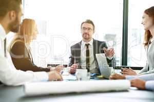 Facilitating their meeting with clear direction. Shot of a team of executives having a formal meeting in a boardroom.
