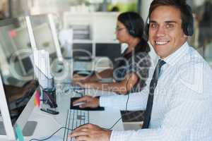 His expertise makes for an excellent customer service experience. Portrait of a happy and confident young man working in a call center.