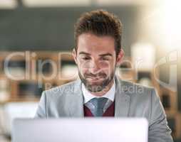 Hes the creator of his own success. Shot of a businessman using a laptop at his office desk.