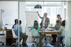 Putting company policies into perspective. Shot of a group of coworkers in a boardroom meeting.