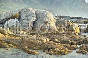 Seascape, landscape, scenic view of boulders and rocks in Hout Bay, Cape Town, South Africa. Ocean, sea washing onto a rocky beach. Travel and tourism abroad, overseas for summer holiday and vacation