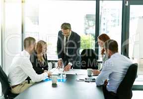 Making sure their meetings are informative and productive. Shot of a team of executives having a formal meeting in a boardroom.