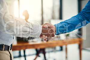 Heres to the start of great things. Closeup shot of businesspeople shaking hands in an office.