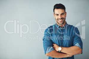 Driven by confidence. Studio portrait of a handsome young man posing against a gray background.