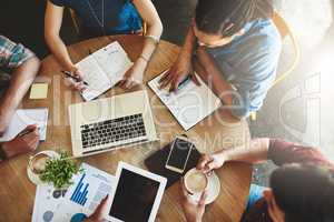 Online study resources can make your life so much easier. High angle shot of a group of students studying in a coffee shop.