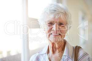 The weathers perfect for a day out. Portrait of a happy elderly woman getting ready to go out.
