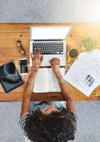 Getting things done more efficiently. Shot of an unrecognizable woman working from home.