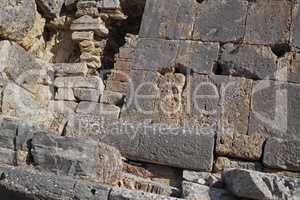 Ancient stone wall ruin on a sunny day. Old or vintage stonework architecture on a building with brown bricks. Antique natural stonewall with a rocky texture outdoors in a sightseeing location