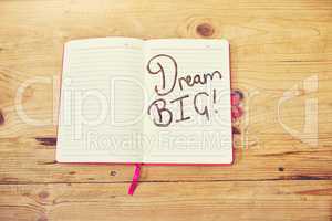 Let your dreams work for you. High angle shot of a creative workstation with a notebook that has the words dream bigwritten on it.