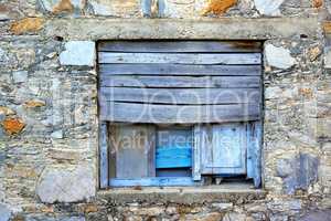 Closeup of an old wooden window on an ancient farmhouse. Historic casement and wall of a vintage or antique building. A tourism or sightseeing location to learn history and vintage architecture
