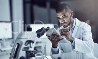 Announcing his findings to the world. Shot of a scientist recording his findings on a digital tablet.