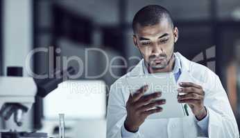 The use of electrical medical records increases. Shot of a scientist recording his findings on a digital tablet.