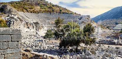 Ancient city ruins of Ephesus in Turkey surrounded by nature. Popular tourism attraction or sightseeing of remains of well preserved historical stone building from classical greek and roman history