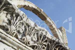 Closeup of Turkey Ephesus arch in an ancient city. Keystone arch with architecture detail patterns. Tourism attraction of well preserved historical stone ruins from classical greek and roman heritage