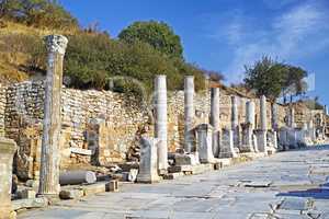Historical Turkey pillars Ephesus in an ancient city. Excavated remains of historical building stone in Turkish history and culture. Ruin of ancient roman architecture in a popular tourism attraction