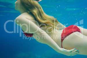 Beautiful woman swimming underwater on paradise beach freedom wellbeing lifestyle summer vacation wanderlust