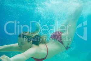 Beautiful woman swimming underwater on paradise beach freedom wellbeing lifestyle summer vacation wanderlust