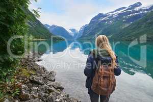 Adventure backpacking woman enjoying view of majestic mountain lake explore travel discover beautiful earth