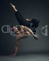 Strength comes from within. Full length shot of a handsome young man performing a martial arts kick in the studio.