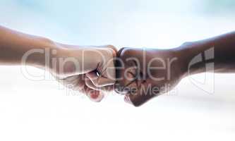 Business cant be stopped. Cropped shot of two unrecognizable businesswomen fist bumping while standing in an office.