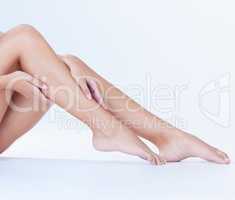 Silky, soft and fresh. Studio shot of an unrecognizable woman showing off her silky smooth legs against a white background.
