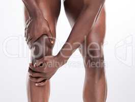 My aching knee. Cropped shot of an unrecognizable man showing discomfort in his knee while posing against a white background.