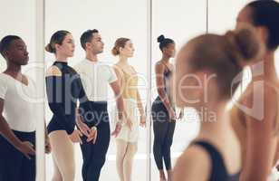 Dance for yourself. a group of ballerinas getting ready to perform in a dance studio.