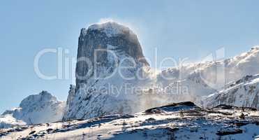 Mountain landscape with snow in the city of Bodoe and its surroundings in the North of the Polar Circle. Scenic view of glacier hills against a blue sky. Nature and natural landmark for tourism