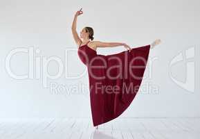 Surrender to the music and see the difference. a young woman dancing in a ballet studio.