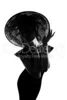 Darling, youre a work of art. Studio shot of a stylish woman in silhouette wearing a wide brimmed hat against a white background.