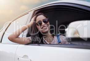 Open windows and wild hearts. Shot of a beautiful young woman enjoying an adventurous ride in a car.