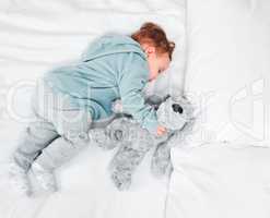 Taking a nap with my snuggle buddy. an adorable baby boy sleeping on a bed.