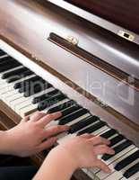 Hands learning to play piano at home in a calm atmosphere. Person composing relaxing classical music using a musical keyboard. A pianist improving and practicing to master the classic instrument.