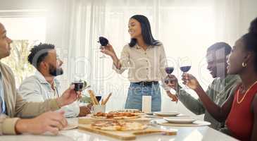 To my friends who stay by my side through the good and bad. Shot of a group of people sharing a toast around the dining table in a house.